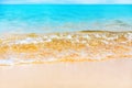 Blue sea wave splash closeup, ocean tide, turquoise water, white foam, golden yellow sand, sunny tropical island beach nature Royalty Free Stock Photo