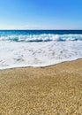 Blue sea wave, white foam, golden sand of sea coast. travel concept, summer vacation, background Royalty Free Stock Photo