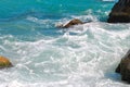 Blue sea waves breaking on stones closeup Royalty Free Stock Photo