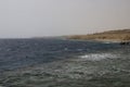 Blue sea and yellow sand beach with pier Royalty Free Stock Photo