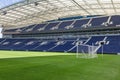 Blue Seatings, Green Pitch, Gallery and Goal inside Empty Stadium Before Soccer Match