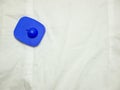 Blue security tag on white shirt Royalty Free Stock Photo
