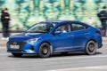 Blue sedan car Hyundai Solaris (Accent) fast speed driving on the asphalt road