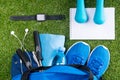 Blue set of things for cardio workout, on a green lawn with a smart clock Royalty Free Stock Photo