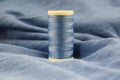 Blue sewing thread on blue fabric.