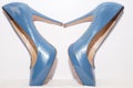 Blue sexy high-heeled shoes isolated on a white carpet. Royalty Free Stock Photo