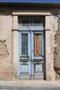 Shabby wooden door in old stone wall Royalty Free Stock Photo