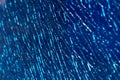 Blue shattered glass completely covered with cracks, creating a fragmented, textured surface with sharp patterns and a dramatic Royalty Free Stock Photo