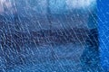 Blue shattered glass completely covered with cracks, creating a fragmented, textured surface with sharp patterns and a dramatic Royalty Free Stock Photo