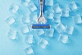 Blue shaving machine with sharp blades on the background of ice cubes close-up Royalty Free Stock Photo