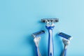 Blue shaving machines in a row on a blue background with ice cubes Royalty Free Stock Photo
