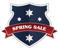 Blue shield and red ribbon with SPRING SALE text. Royalty Free Stock Photo