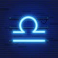 Blue shining cosmic neon zodiac Libra symbol on brick wall background. Astrology concept. Royalty Free Stock Photo