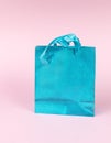 A blue shiny gift bag on a pink background Royalty Free Stock Photo