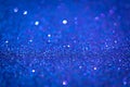 Blue shiny glitter texture. Selective focus. Glowing surface, sparkle lights and bokeh effects. Christmas and festive Royalty Free Stock Photo