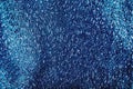 Blue shiny glitter textured textile background with glow Royalty Free Stock Photo