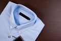 Blue shirt with black blank price tag. Royalty Free Stock Photo