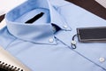 Blue shirt with black blank price tag on wooden table. Royalty Free Stock Photo