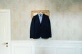 Blue shirt and black jacket on clothes hanger Royalty Free Stock Photo