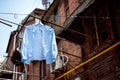 Blue shirt hanging on a washing line in a traditional alley in the old town of Shanghai