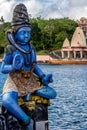 Blue Shiva statue and a temple Royalty Free Stock Photo