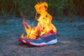 Blue shoes on the ground and on fire Royalty Free Stock Photo