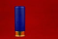 Blue Shotgun Cartridge on a Red Background