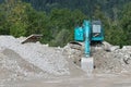 Blue shovel digger on gravel heap