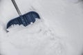 Blue shovel in the snow