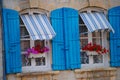Blue Shutter Windows with Flower Pots Royalty Free Stock Photo