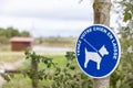 Blue sign authorizing the walking of dogs with leash