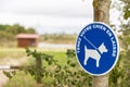 Blue sign authorizing the walking of dogs with leash