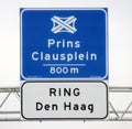 Blue sign marking the coming crossing node of motorways at the A12 and A4 named prins clausplein as part of the ring Den Haag.