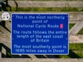 A blue sign marking the most northerly point of UK National Cycle Route 1, in Skaw on the island of Unst in Shetland, Scotland, UK