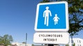 Blue sign pedestrian route road and french text cyclomoteur interdit means forbidden moped scooter banned Royalty Free Stock Photo