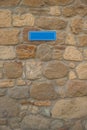 Blue sign on stone wall Royalty Free Stock Photo