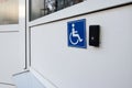 Blue sign with a wheelchair and a call button for staff to help move the disabled and people with disabilities Royalty Free Stock Photo