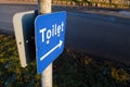 Blue toilet sign to public restrooms Royalty Free Stock Photo