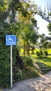 Blue signboard, sign or symbol for disabled wheelchairs to tell direction and way to get up cafÃÂ© shop with pathway