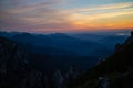 Blue silhouettes of Carpathian rocky mountains and sunset orange-blue sky with clouds Royalty Free Stock Photo
