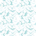 Blue silhouettes of seagulls flying in the sky. Seamless pattern with birds. Royalty Free Stock Photo
