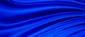 Blue silk background illustration of flowing wavy folds in draped cloth, abstract blurred material or fabric texture pattern in lu Royalty Free Stock Photo