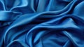 A blue silk cloth is draped over a table with soft light