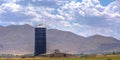 Blue silo and barn on a farm overlooking mountain Royalty Free Stock Photo