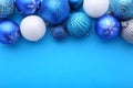 Blue and silver Christmas balls on a blue background. Royalty Free Stock Photo