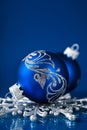 Blue and silver christmas ornaments on dark blue background Royalty Free Stock Photo