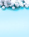 Blue and silver Christmas toys-balls and branches of white spruce on light blue. Royalty Free Stock Photo