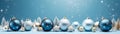 Blue, silver and golden Christmas balls and decorations in a row on a blue surface and background. Royalty Free Stock Photo