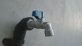 Skewed blue-silver outdoor water faucet