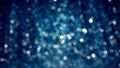 Blue Silver sparkle glitter tinsel with bokeh effect and selective focus. Festive background with bright gold raining lights. Chri Royalty Free Stock Photo